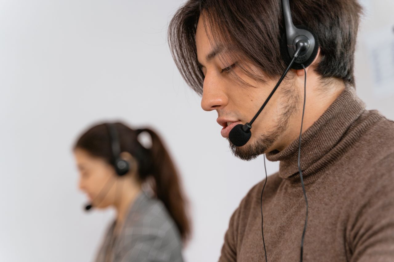 services-04 Focused call center employees wearing headsets, assisting customers with exceptional service.