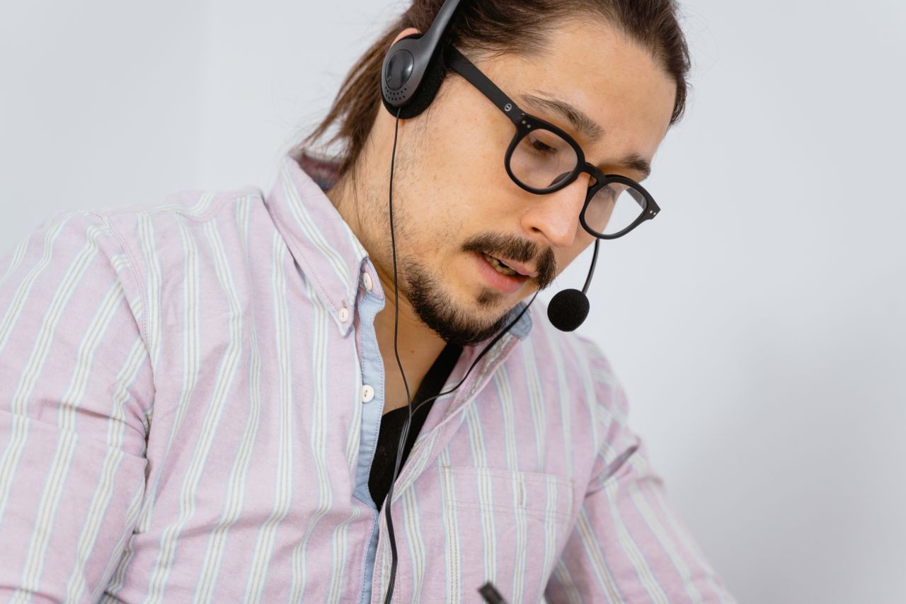 services-01 Focused call center agent with headset providing customer support.